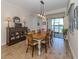 Dining area featuring stylish furnishings and a large window with beautiful views of the lake at 26825 Weiskopf Dr, Englewood, FL 34223