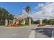 Community entrance with signage, lush landscaping and a charming guard house at the entry at 26825 Weiskopf Dr, Englewood, FL 34223