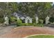 Gated community entrance featuring lush landscaping and a guard house at 26825 Weiskopf Dr, Englewood, FL 34223
