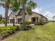 Charming home with a three car garage, desert landscaping and an inviting front porch at 26825 Weiskopf Dr, Englewood, FL 34223