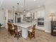 Charming kitchen featuring modern appliances, a large island, and sleek white cabinetry at 26825 Weiskopf Dr, Englewood, FL 34223