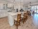 Open kitchen boasts a large island with seating and modern appliances, perfect for entertaining and everyday living at 26825 Weiskopf Dr, Englewood, FL 34223