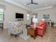 Cozy living room is bright and features tiled floors, a ceiling fan and neutral paint at 26825 Weiskopf Dr, Englewood, FL 34223