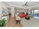 Bright open-concept living room with comfortable seating and scenic views of the lake at 26825 Weiskopf Dr, Englewood, FL 34223