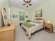 Inviting bedroom with green walls, a ceiling fan and well-decorated furnishings at 26825 Weiskopf Dr, Englewood, FL 34223