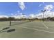 Well-maintained tennis courts surrounded by lush landscaping and bright lights at 26825 Weiskopf Dr, Englewood, FL 34223