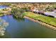 Lakefront aerial view showcasing neighborhood, lakeside living, and lush green landscaping at 3203 Meadow Run Dr, Venice, FL 34293