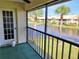 View from the screened patio overlooking a peaceful pond and palm tree views at 345 Three Lakes Ln # L, Venice, FL 34285