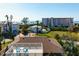 Two-story home with roof deck surrounded by lush greenery, set against the backdrop of the ocean at 397 Flamingo Dr, Venice, FL 34285