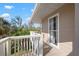 Cozy balcony with white railing and trim offering a tranquil outdoor space and verdant treetop views at 397 Flamingo Dr, Venice, FL 34285