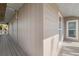 Exterior corner balcony featuring wood floors, railings, and neutral siding with natural surroundings at 397 Flamingo Dr, Venice, FL 34285