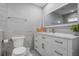Bathroom features a white vanity with marble top, a large mirror and decorative fish at 397 Flamingo Dr, Venice, FL 34285