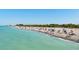 Scenic view of a sunny beach with people enjoying the ocean, sand, and blue sky at 397 Flamingo Dr, Venice, FL 34285