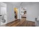 Bedroom with wood floors and views of the bathroom, laundry and living room at 397 Flamingo Dr, Venice, FL 34285
