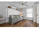 Comfortable bedroom with wood floors, a murphy bed, and a sunny window at 397 Flamingo Dr, Venice, FL 34285