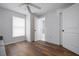 Bright bedroom with wood floors, a large window, and an attached bathroom at 397 Flamingo Dr, Venice, FL 34285