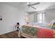 Cozy bedroom featuring wood floors, a ceiling fan, and an open doorway at 397 Flamingo Dr, Venice, FL 34285