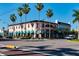 A charming historic building at a street corner with palm trees and shops with awnings at 397 Flamingo Dr, Venice, FL 34285