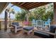Back deck with seating area surrounded by tropical trees at 397 Flamingo Dr, Venice, FL 34285