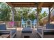 Back deck with seating area surrounded by tropical trees at 397 Flamingo Dr, Venice, FL 34285