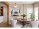 Bright dining area with a round wooden table and comfortable upholstered chairs, open to the kitchen at 397 Flamingo Dr, Venice, FL 34285