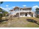 Charming coastal house with dual balconies, side staircase, and a well-maintained lawn at 397 Flamingo Dr, Venice, FL 34285