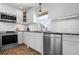 Modern kitchen featuring stainless steel appliances, granite countertops, and white subway tile backsplash at 397 Flamingo Dr, Venice, FL 34285