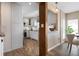 Open-concept kitchen with white cabinets, stainless steel appliances, and a brick-style floor at 397 Flamingo Dr, Venice, FL 34285
