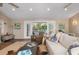 Inviting living area boasts sliding glass doors to an outdoor deck, stylish decor and ceiling fans at 397 Flamingo Dr, Venice, FL 34285