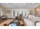 Inviting living area boasts sliding glass doors to an outdoor deck, stylish decor and ceiling fans at 397 Flamingo Dr, Venice, FL 34285