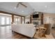 Open-concept living room with a stone fireplace and wood beam columns at 397 Flamingo Dr, Venice, FL 34285