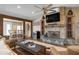 Open-concept living room with a stone fireplace and wood beam columns at 397 Flamingo Dr, Venice, FL 34285