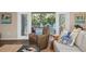 Inviting living area boasts sliding glass doors to an outdoor deck, stylish decor and ceiling fans at 397 Flamingo Dr, Venice, FL 34285