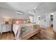 Bright main bedroom with a colorful quilt, ceiling fan and ensuite bathroom with walk-in closet at 397 Flamingo Dr, Venice, FL 34285