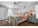 Bright main bedroom with a colorful quilt, ceiling fan and ensuite bathroom with walk-in closet at 397 Flamingo Dr, Venice, FL 34285