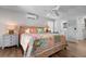 Bright main bedroom with a colorful quilt, ceiling fan and ensuite bathroom with walk-in closet at 397 Flamingo Dr, Venice, FL 34285