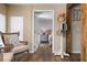 Comfortable sitting room with a view into a serene bedroom, featuring neutral decor and stylish accents at 397 Flamingo Dr, Venice, FL 34285