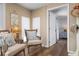 Cozy sitting room with neutral tones, comfortable seating, and a view into an adjacent bedroom at 397 Flamingo Dr, Venice, FL 34285