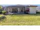 An exterior view of the home's screened patio and manicured backyard at 4238 Mackay Falls Ter, Sarasota, FL 34243