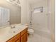 Bathroom featuring a single vanity, a window, and a shower-tub combo with white tiling at 4238 Mackay Falls Ter, Sarasota, FL 34243