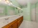Bathroom with a double vanity, a large mirror, and a separate shower and tub area at 4238 Mackay Falls Ter, Sarasota, FL 34243