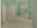 Bright bathroom featuring a soaking tub, a separate shower, and tiled floors at 4238 Mackay Falls Ter, Sarasota, FL 34243