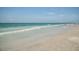 Beautiful beach featuring gentle waves, clear turquoise waters, and pristine white sand at 4238 Mackay Falls Ter, Sarasota, FL 34243