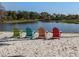 Comfortable lounge chairs facing a tranquil beach and lake at 4238 Mackay Falls Ter, Sarasota, FL 34243