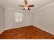 Bright bedroom with wood floors, fan, and a window at 4238 Mackay Falls Ter, Sarasota, FL 34243
