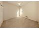 Bedroom with neutral walls, carpeted floors, and a window providing natural light at 4238 Mackay Falls Ter, Sarasota, FL 34243