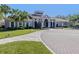 Exterior of clubhouse featuring manicured landscaping and sidewalks with decorative lighting at 4238 Mackay Falls Ter, Sarasota, FL 34243