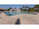 Large community pool with ample deck space and lounge chairs surrounded by mature landscaping at 4238 Mackay Falls Ter, Sarasota, FL 34243
