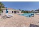 Community pool with lounge chairs and umbrellas, perfect for relaxing by the water at 4238 Mackay Falls Ter, Sarasota, FL 34243