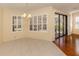 Bright dining area with chandelier lighting, plantation shutters, and view of the lanai at 4238 Mackay Falls Ter, Sarasota, FL 34243